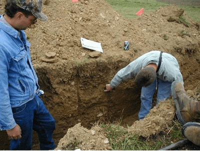 Two people in a soil pit
